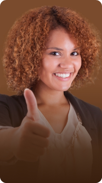 A smiling woman giving a thumbs-up