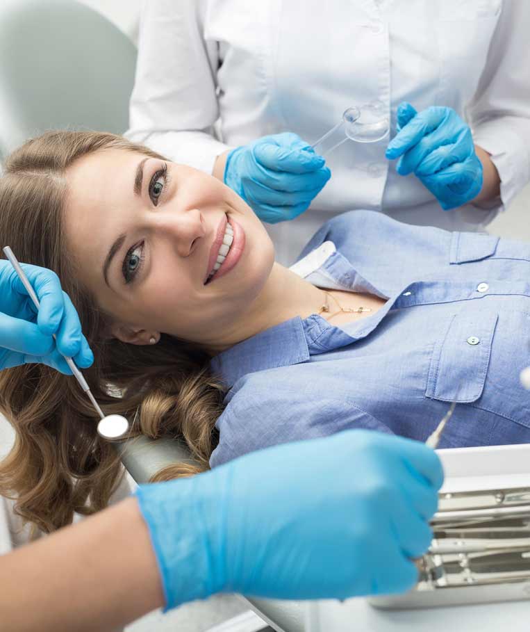 A woman preparing for a dental exam at a dental clinic in Stafford, VA
