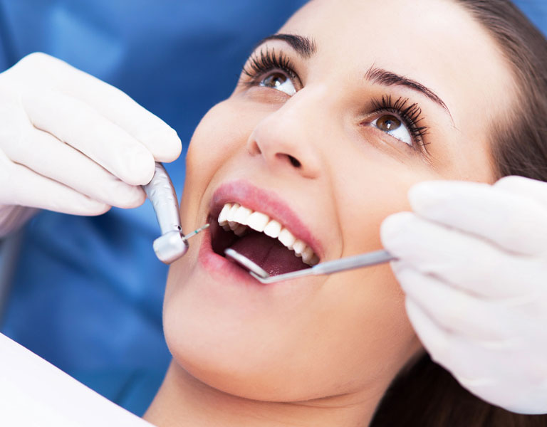 Dentist examining a patient’s teeth at a dental office in Stafford, VA
