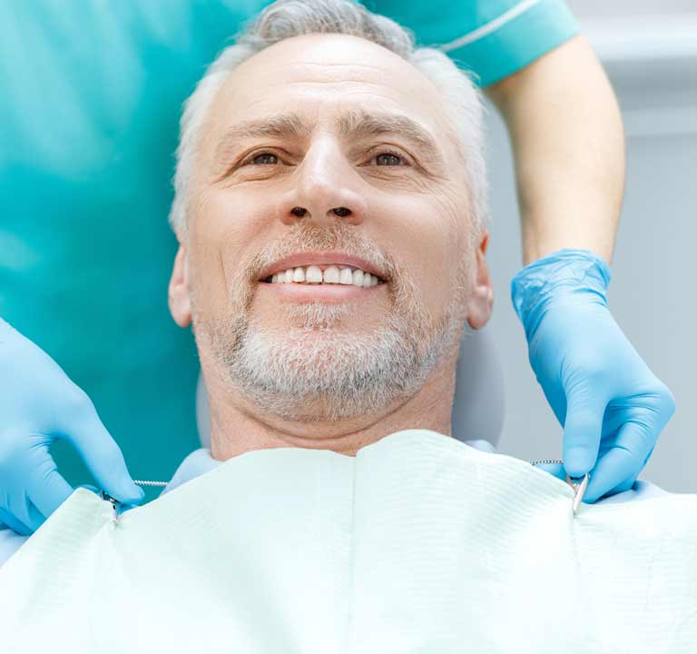 Happy senior man smiling after dental implant treatment in Stafford, VA