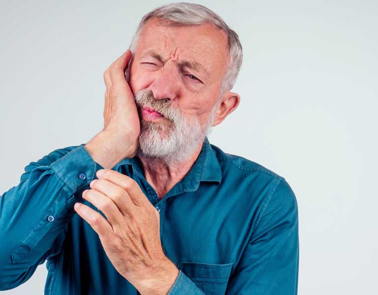 Senior man suffering from jaw pain in Stafford, VA