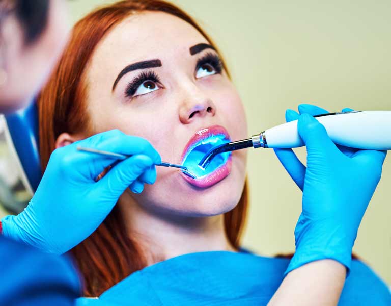 Woman receiving laser dental treatment at a dental clinic in Stafford, VA