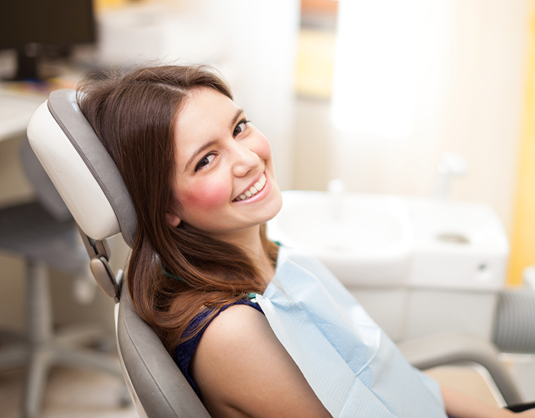 A woman sitting on a dental chair